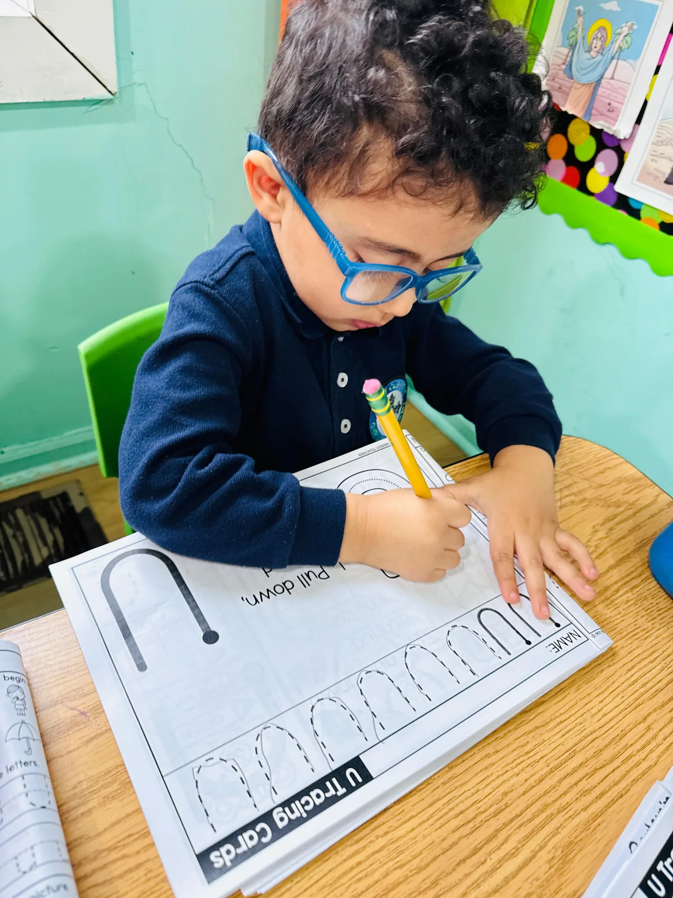 Preschool child practicing early handwriting skills